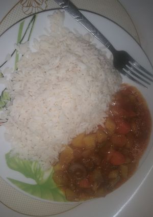 A picture of White rice and hearty beef stew.
