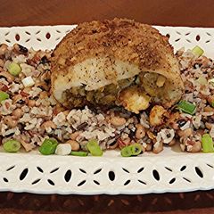 A picture of Cajun Stuffed Catfish on Creole Wild Rice.