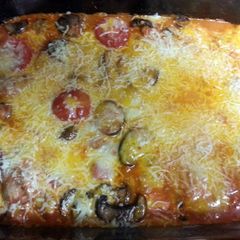 A picture of Cheese raviolis with mushrooms and tomatoes.