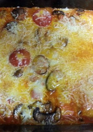 A picture of Cheese raviolis with mushrooms and tomatoes.
