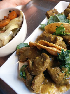 A picture of Curry sirloin tacos with bacon veggies.
