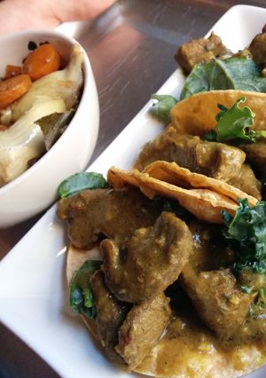 A picture of Curry sirloin tacos with bacon veggies.