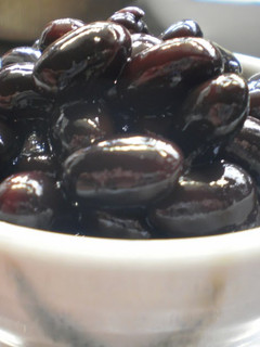 A picture of Plump and Juicy 'Kuromame' Simmered Black Soy Beans.