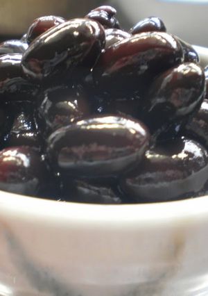 A picture of Plump and Juicy 'Kuromame' Simmered Black Soy Beans.
