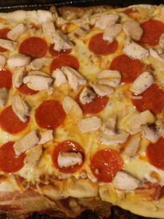 A picture of Bacon crusted pizza.