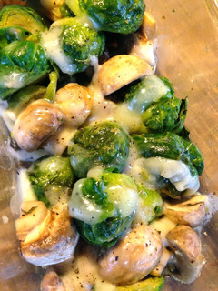 A picture of Brussels Sprouts and Mushrooms with Cheese.