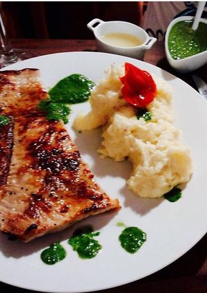 Una foto de Matambre de cerdo al limón con puré de papas y vinagreta de rúcula