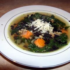 A picture of Turkey and kale soup with black rice.
