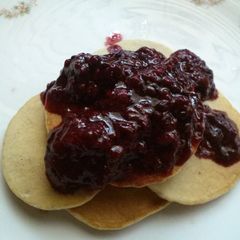 A picture of Momma's blueberry pancakes and homemade triple berry syrup.