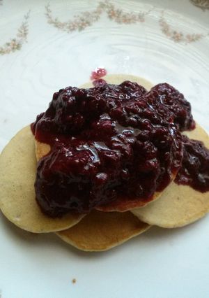 A picture of Momma's blueberry pancakes and homemade triple berry syrup.