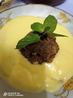 A picture of Chocolate bread pudding with custard sauce.