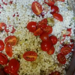 A picture of Israeli Couscous with leeks and cherry tomatoes.