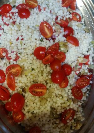 A picture of Israeli Couscous with leeks and cherry tomatoes.