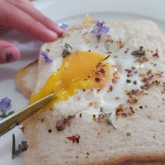 A picture of Savoury Rosemary Flower Egg in a Hole.