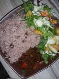 Boiled rice and beans with onion sauce and salad