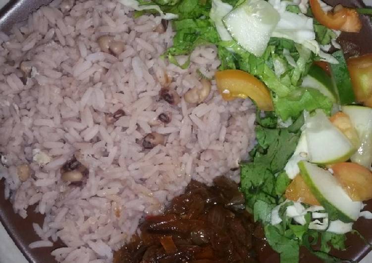 Boiled rice and beans with onion sauce and salad