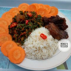 A picture of White rice,vegetables and garnished with carrots.