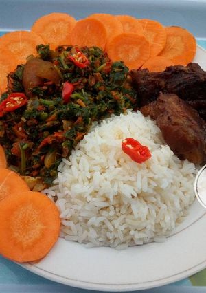 A picture of White rice,vegetables and garnished with carrots.