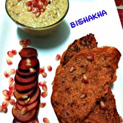 A picture of Hummus with Beetroot Chila.