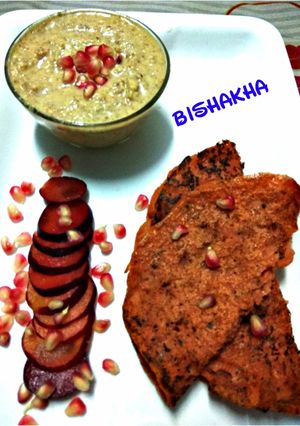 A picture of Hummus with Beetroot Chila.