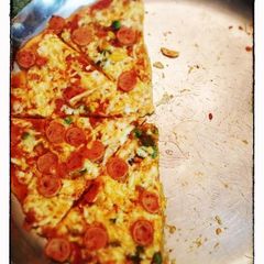 A picture of Whole wheat pizza with sausage topping.