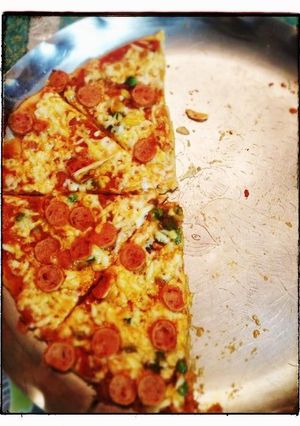 A picture of Whole wheat pizza with sausage topping.