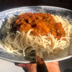 A picture of Minced meat sauce with spaghetti.