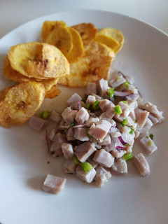 Una foto de Ceviche con limón, cebolla roja y pimiento verde