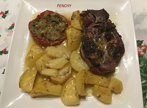 Foto principal de Chuletas de cabeza asadas con tomates rellenos al ajo