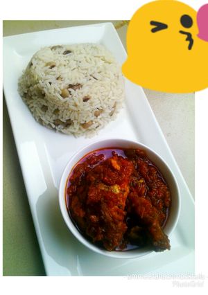 A picture of Rice and beans with chicken stew.