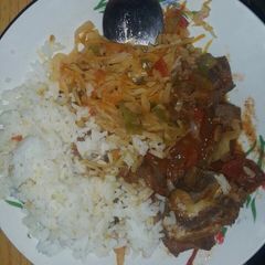 A picture of Boiled rice served with cabbage and beef stew.