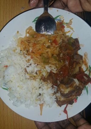A picture of Boiled rice served with cabbage and beef stew.