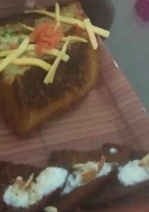 A picture of Bread cheesy sandwich with bread khasta jalebi.