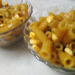 A picture of Pea pasta with corn toppings.