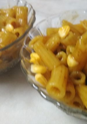 A picture of Pea pasta with corn toppings.