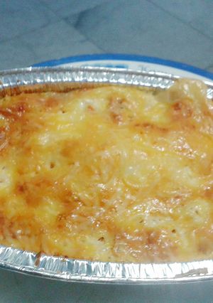 A picture of baked eggs with bacon & cheese.
