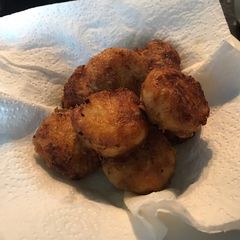 A picture of Golden brown potato nuggets.