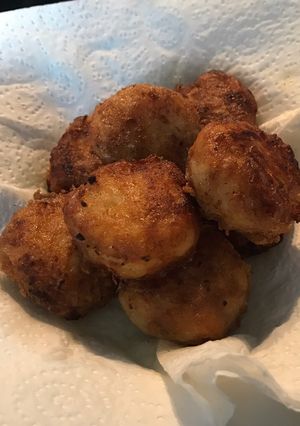 A picture of Golden brown potato nuggets.