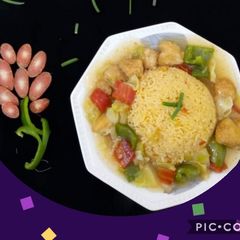 A picture of Fried rice with chicken chilli.