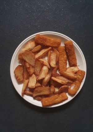 A picture of Triple cooked deep fried Chips and Fish Fingers.