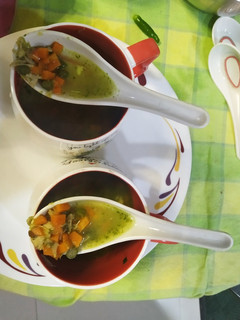 A picture of Chicken coriander soup with vegetables.