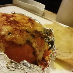 A picture of Baked Tomato,stuffed with Egg,Spinach n Ham.
