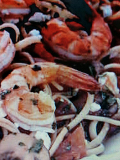 A picture of Linguini w/shrimp and plum tomatoes.