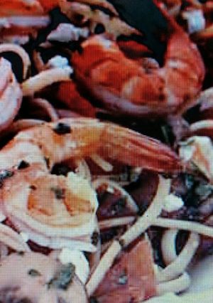 A picture of Linguini w/shrimp and plum tomatoes.