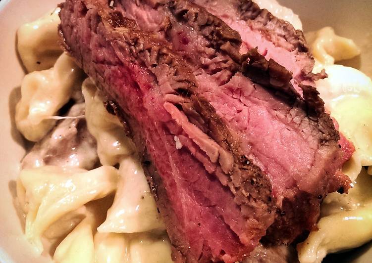 Flank Steak over Tortellini in Parmesan Cream sauce