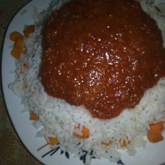 A picture of White rice with carrot and stew.