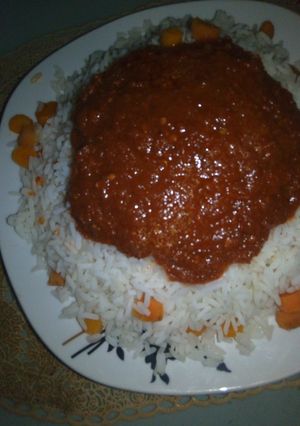 A picture of White rice with carrot and stew.