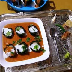 A picture of Paneer stuffed Spinach Kofta Curry.