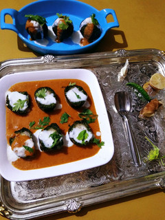 A picture of Paneer stuffed Spinach Kofta Curry.