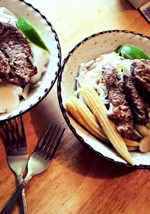 A picture of Iowa pork tenderloin and Vietnamese noodle bowl.
